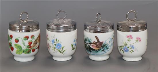 Eighteen porcelain egg coddlers, including Wedgwood Peter Rabbit, Spode Christmas Tree and Royal Worcester examples